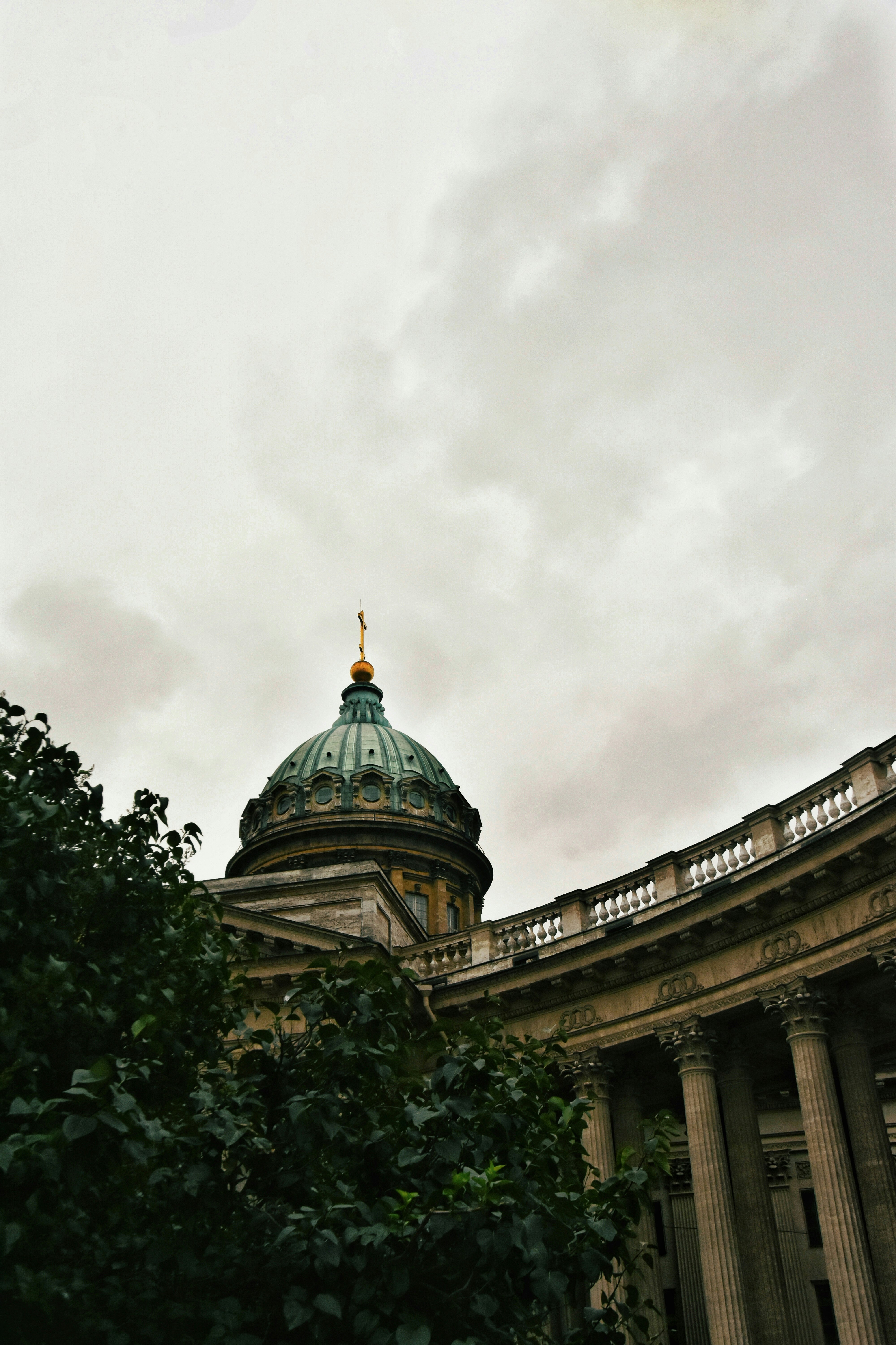 green and brown dome building under white clouds